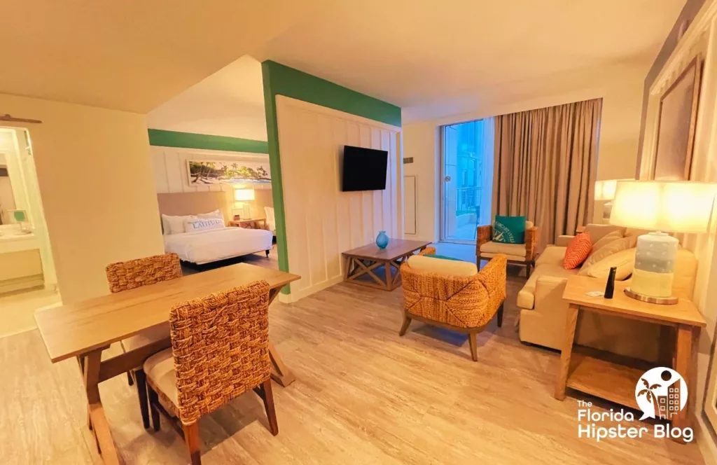 Margaritaville Resort Jacksonville suite with dining area, view of the bedroom and living full of beach décor. Keep reading to learn more about Margaritaville Hotel Jacksonville Beach.