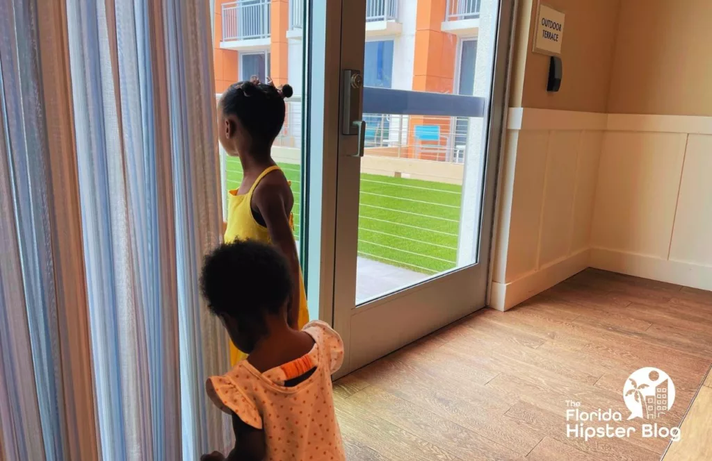 Margaritaville Resort Jacksonville with two little black girls looking out the window. Keep reading to discover all there is to know about Margaritaville Beach Hotel Jacksonville.