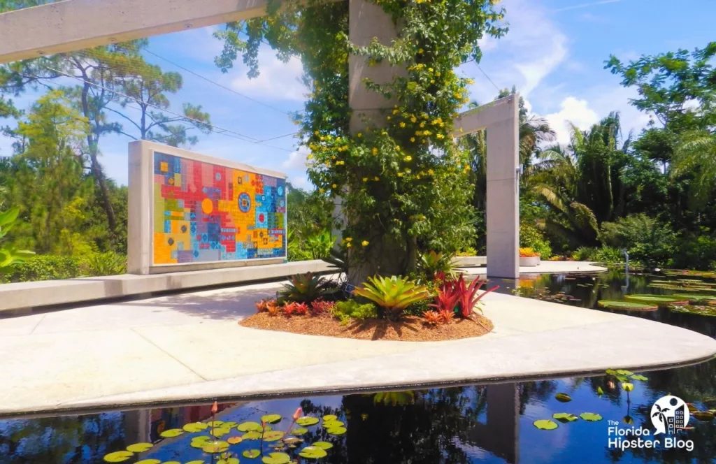 Naples, Florida mosaic area next to water lily pads at the Naples Botanical Garden. Keep reading to get the best places to have brunch in Naples.