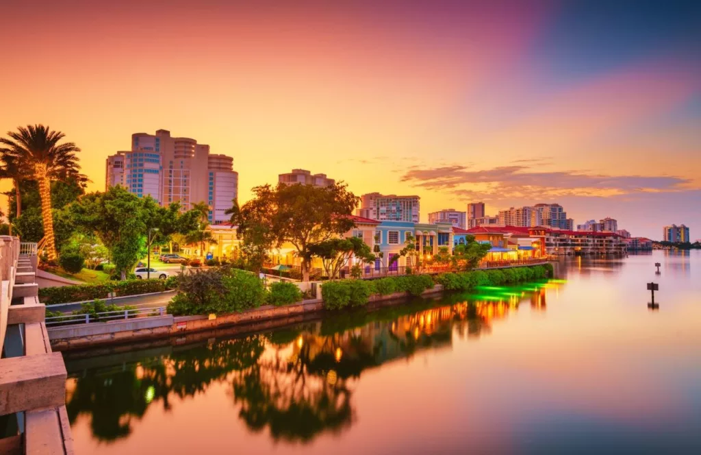 Naples, Florida skyline at night with bay area and homes. Keep reading to learn about the best Florida beaches for a girl's trip!