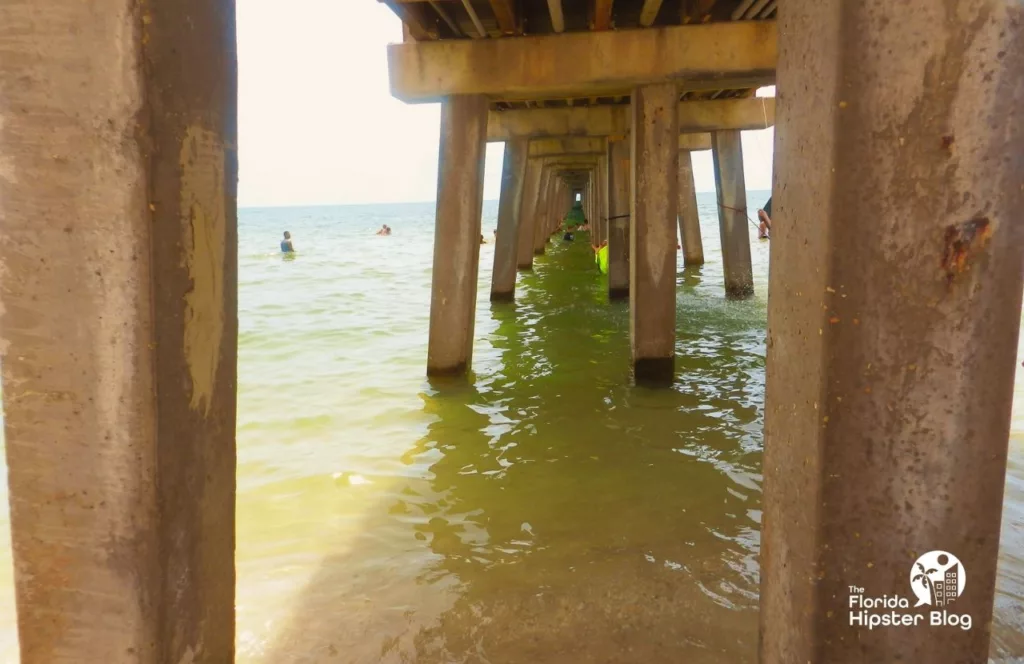 Naples, Florida under the pier at the beach. Keep reading to learn about the best Florida beaches for a girl's trip!
