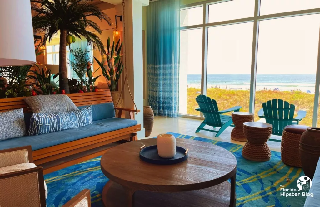  Margaritaville Beach Hotel Lobby with Adirondack chairs looking out at the beach and beach style décor. Keep reading to find out all about Margaritaville Hotel Jacksonville Beach.