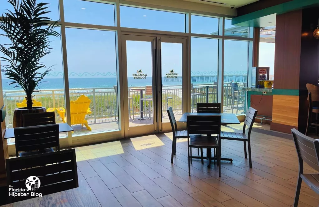 Margaritaville Beach Hotel lobby and Landshark Lookout area facing out to the bright blue Atlantic Ocean. 