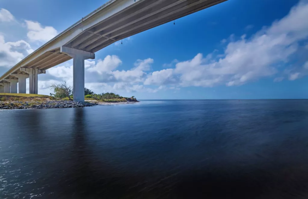 Port Saint Joe bridge going over Gulf of Mexico. Keep reading to get the best things to do in the Florida Panhandle.