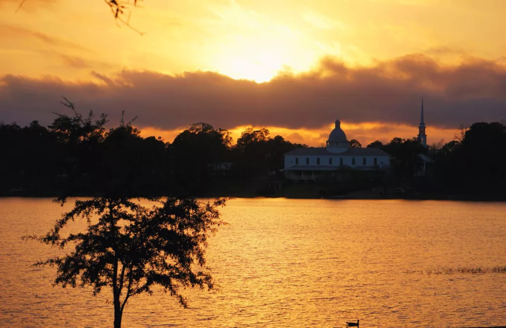 Sunset on Lake DeFuniak Springs. Keep reading to get the best things to do in the Florida Panhandle