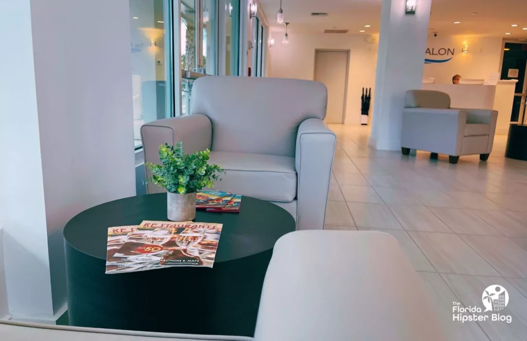 The Avalon Hotel in Clearwater lobby with grey modern seating and tranquil space. Keep reading to learn more about The Avalon Club Hotel.