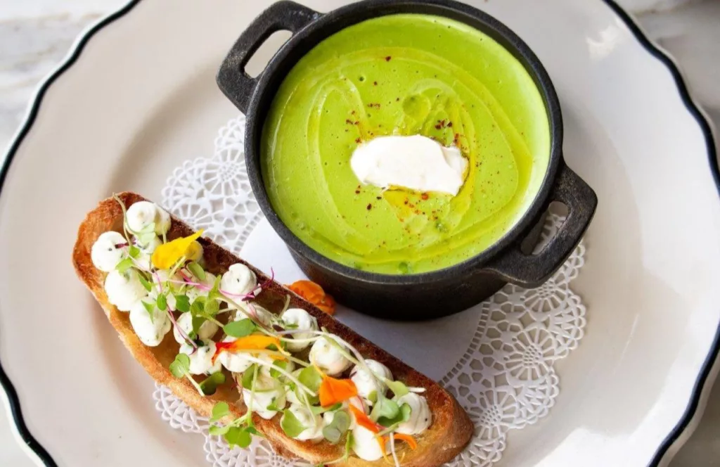 The French with a green soup next to caprese topped on toast. One of the best places to get brunch in Naples, Florida. Keep reading to find out all you need to know about brunch in Naples. 