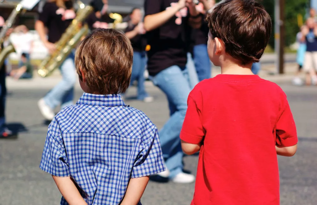 Tribute to Heroes Block Party and Parade in Lakewood Ranch, Florida. One of the best things to do for Memorial Day Weekend in Florida. Keep reading to find out more things to do on Florida Memorial Day weekend.  with boys watching the parade.