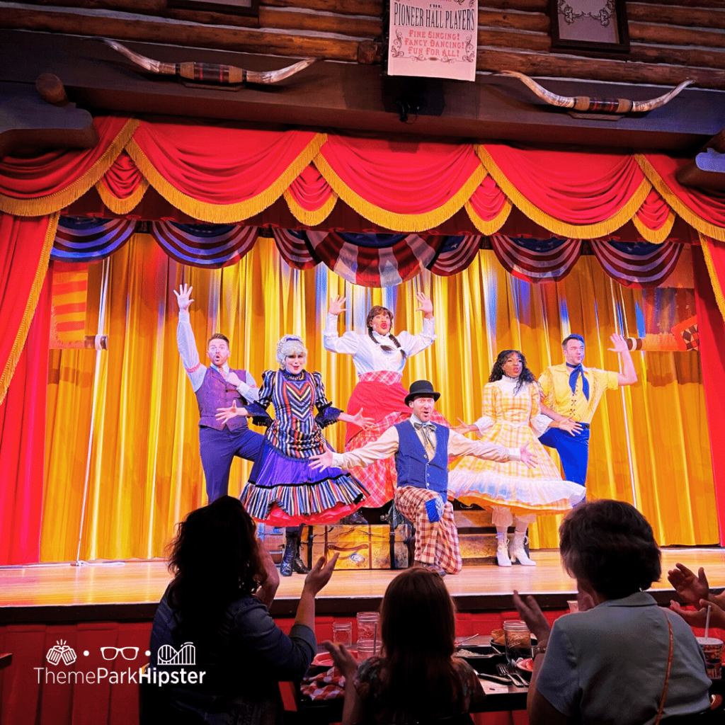 Hoop Dee Doo Revue at Disney World with performers on stage audience members capping and having fun. Keep reading to learn more about Orlando birthday celebrations.