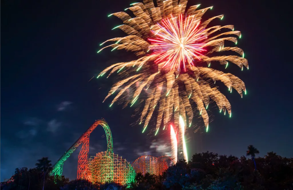 Gwazi next to Fireworks at Busch Gardens Christmas Town. Keep reading to learn more about the best events in Florida for the 4th of July. 