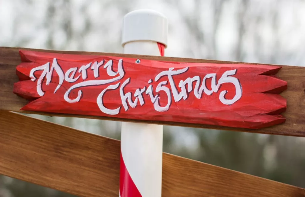 Merry Christmas wooden sign. Keep reading to discover more Christmas in Orlando events.