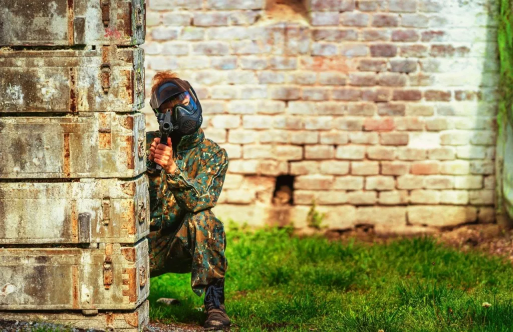 Battleground Orlando with lady bench down playing game. One of the Best Paintball Fields in Orlando, Florida. Keep reading to discover all there is to know about Orlando paintball fields.