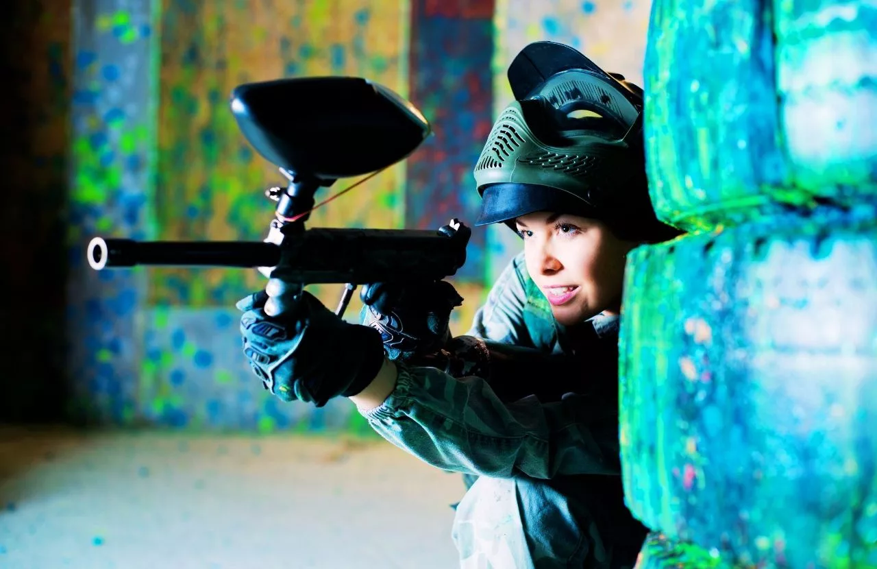 Lady having fun playing the game. Travel Guide to the Best Paintball Fields in Orlando, Florida