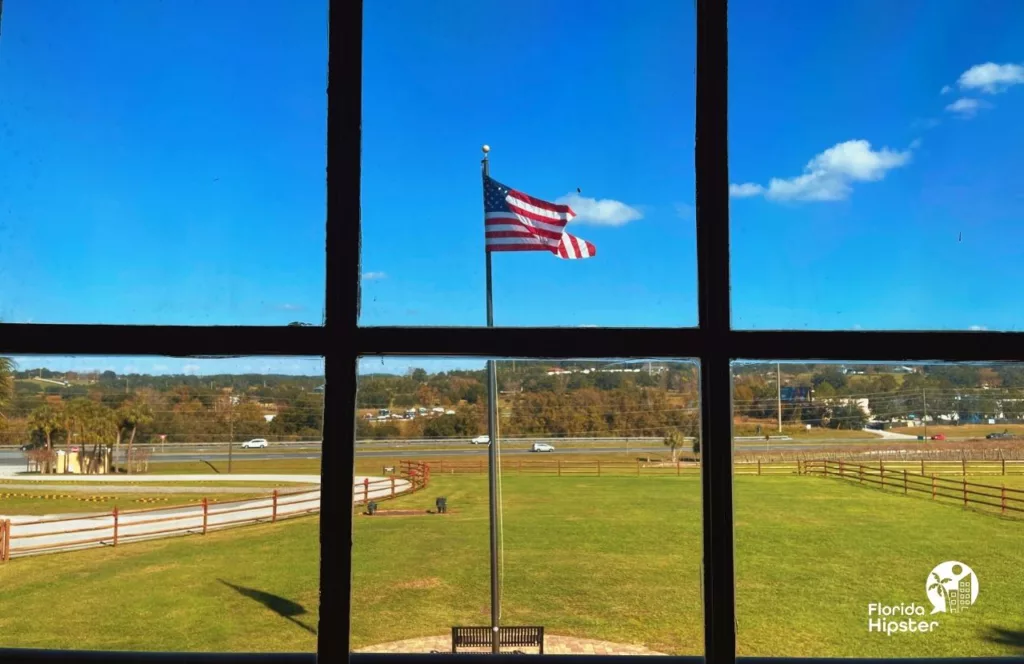View of Lakeridge Winery in Clermont, Florida and American flag on its sprawling property. Keep reading to find out more about the best Winery in Florida, Lakeridge Winery in Clermont, Florida. 