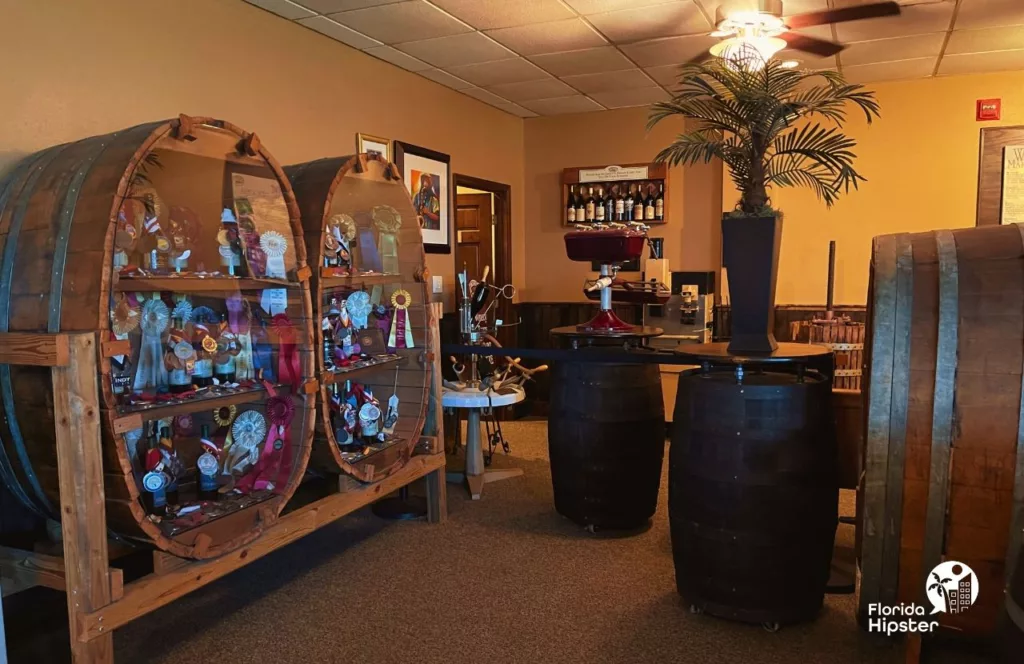 Lakeridge Winery in Clermont, Florida tour area with barrel tables, wines and awards. Keep reading to learn more about Lakeridge Winery & Vineyards.