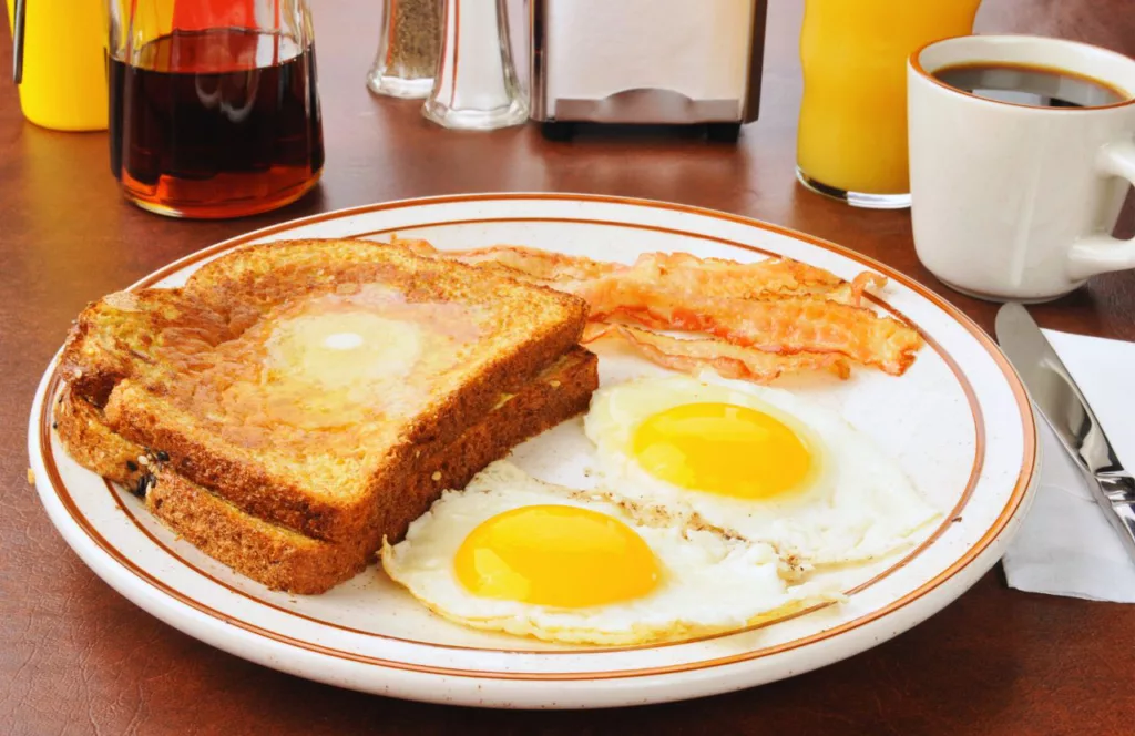 Liza’s Kitchen Café with toast eggs bacon and coffee. One of the best places to get breakfast in Panama City Beach. Keep reading to find out more about the best breakfast in Panama City Beach, Florida. 