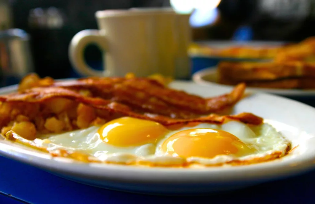 Sunrise Café & Bakery with eggs and bacon. One of the best places to get breakfast in Panama City Beach, Florida. Keep reading to find out more about the best place to eat in Panama City Beach, Florida.