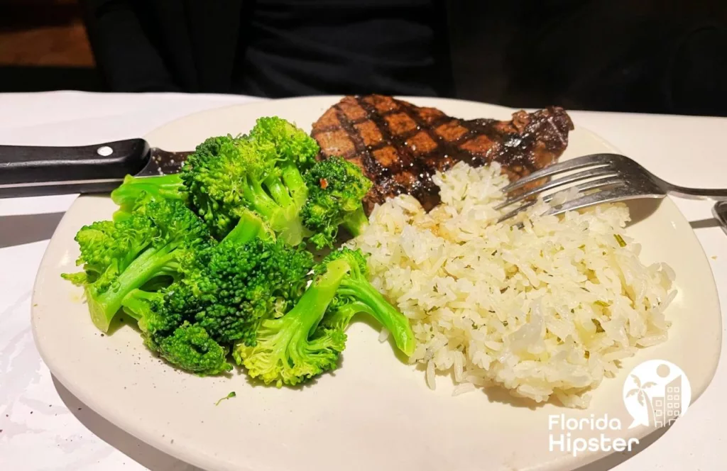 Bonefish Grill Filet Mignon Steak and broccoli with rice. One of the best restaurants in Orlando, Florida. Keep reading to find out more about Orlando steakhouses.