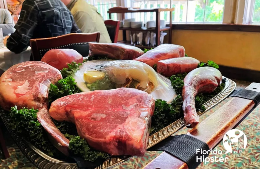Charley's Steakhouse and Seafood Grill with raw meats on display to be grilled. Keep reading to learn more about the best steakhouse in Orlando.