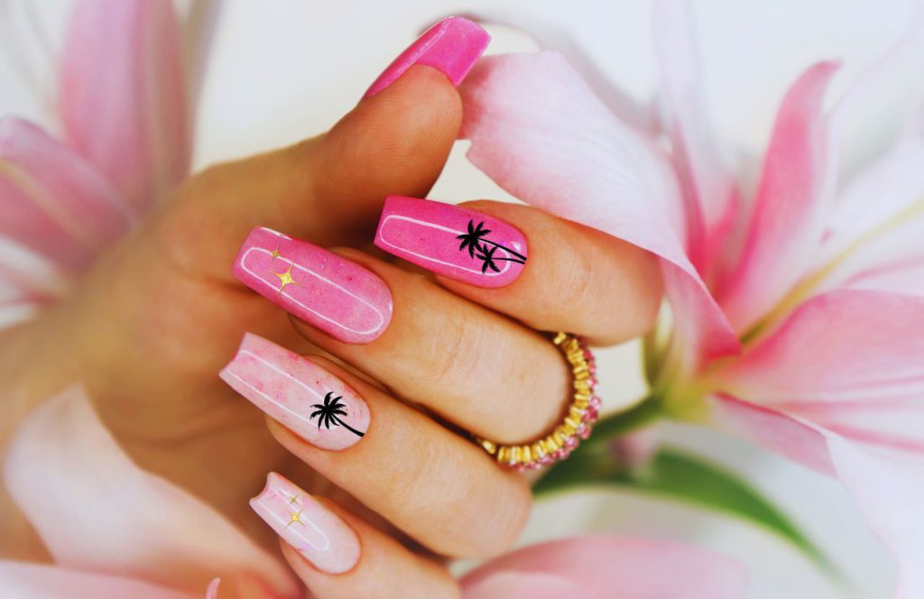 Florida Summer Nails with Palm Trees on Pink Nails. Keep reading for the full guide to the best beach nails for your Florida beach vacation.
